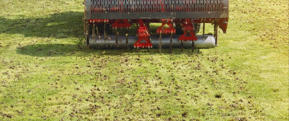 A red aeration machine at work on a property in Malvern, PA.