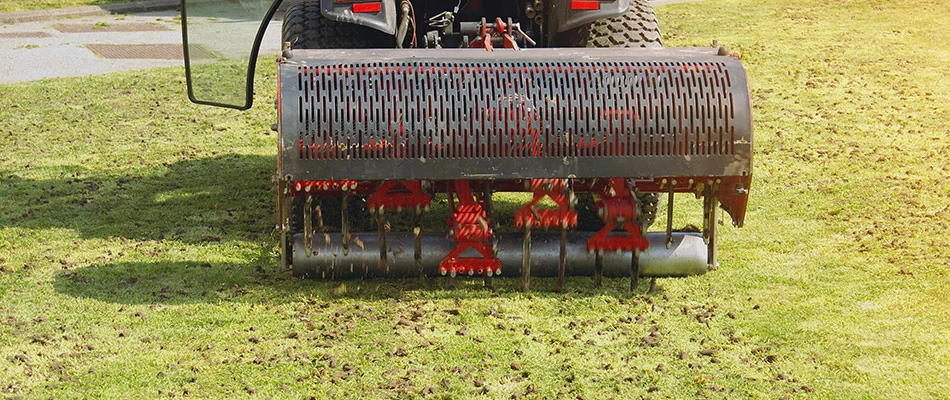 A lawn being professionally aerated for healthy and vibrance near Doylestown, PA